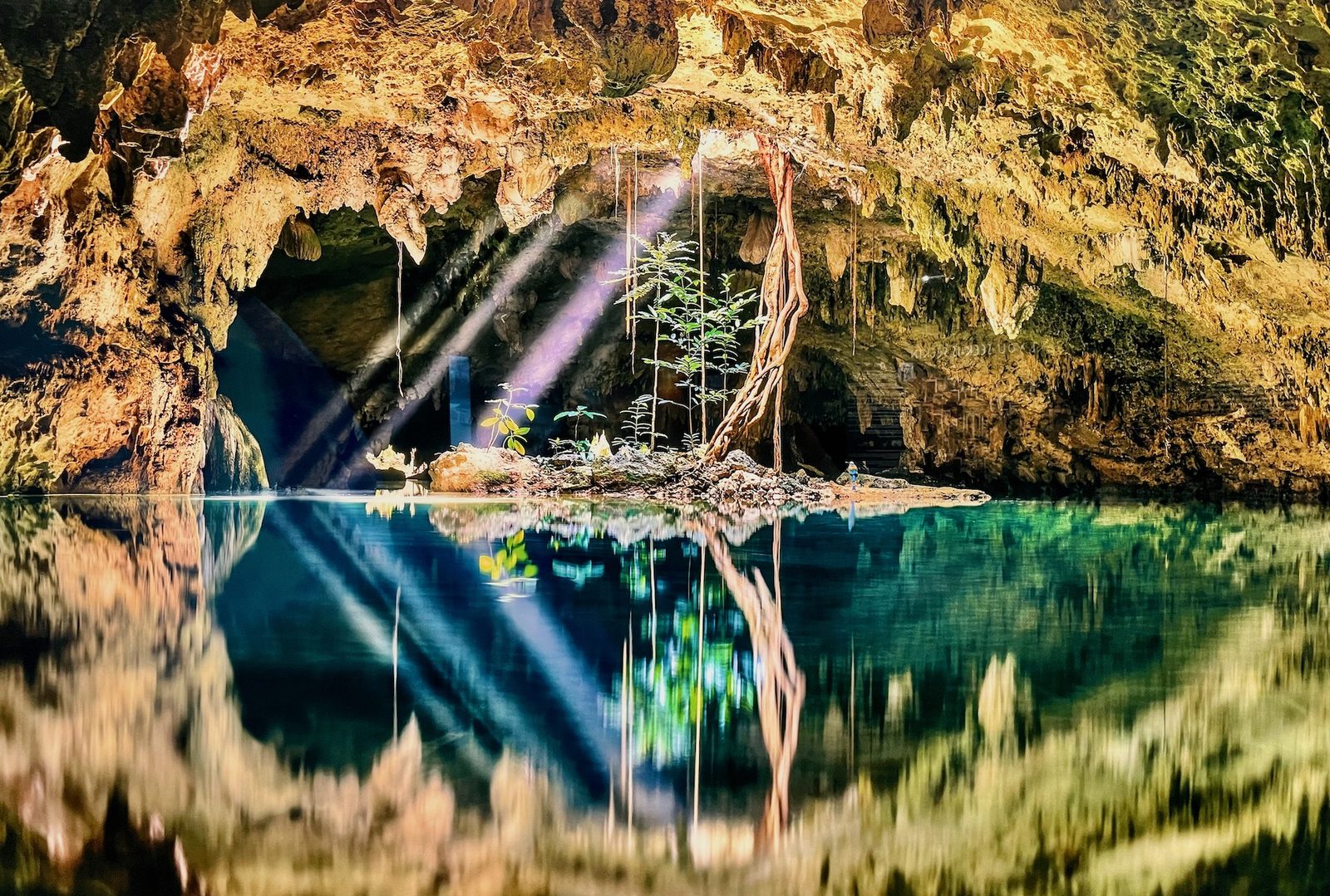 Light beams entering a sacred cave — a metaphor for the inner journey of psychedelic therapy