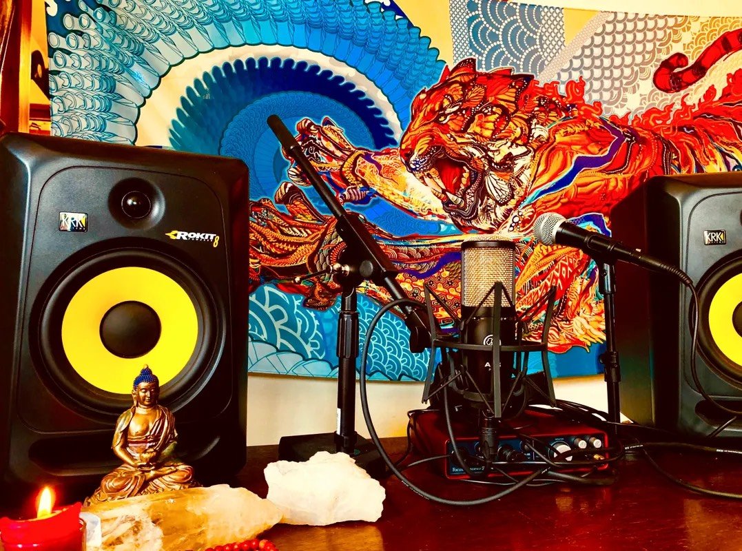 The podcast studio with Buddha statue, microphones, and crystals